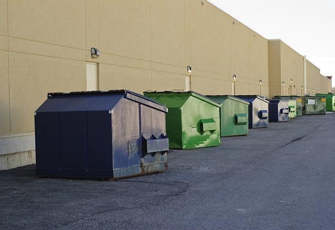 a crowd of dumpsters of all colors and sizes at a construction site in Hales Corners, WI